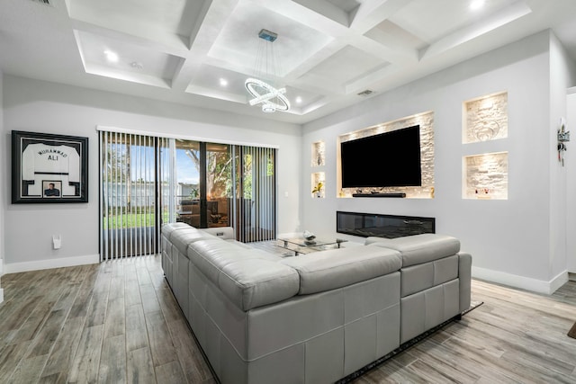 living room featuring coffered ceiling, light wood-style flooring, and baseboards