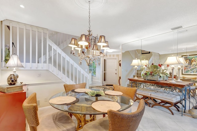 dining area with light tile patterned floors, stairway, and an inviting chandelier