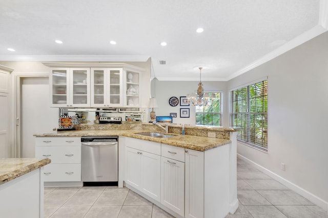 kitchen featuring decorative light fixtures, glass insert cabinets, white cabinets, a sink, and dishwasher