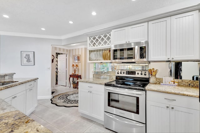 kitchen featuring appliances with stainless steel finishes, white cabinetry, crown molding, and light stone counters