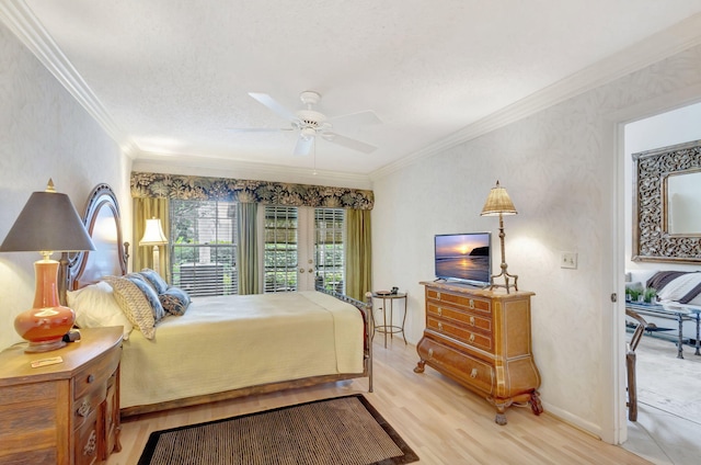 bedroom with crown molding, light wood finished floors, a ceiling fan, a textured ceiling, and baseboards