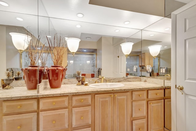 full bath with a shower with door, vanity, and recessed lighting