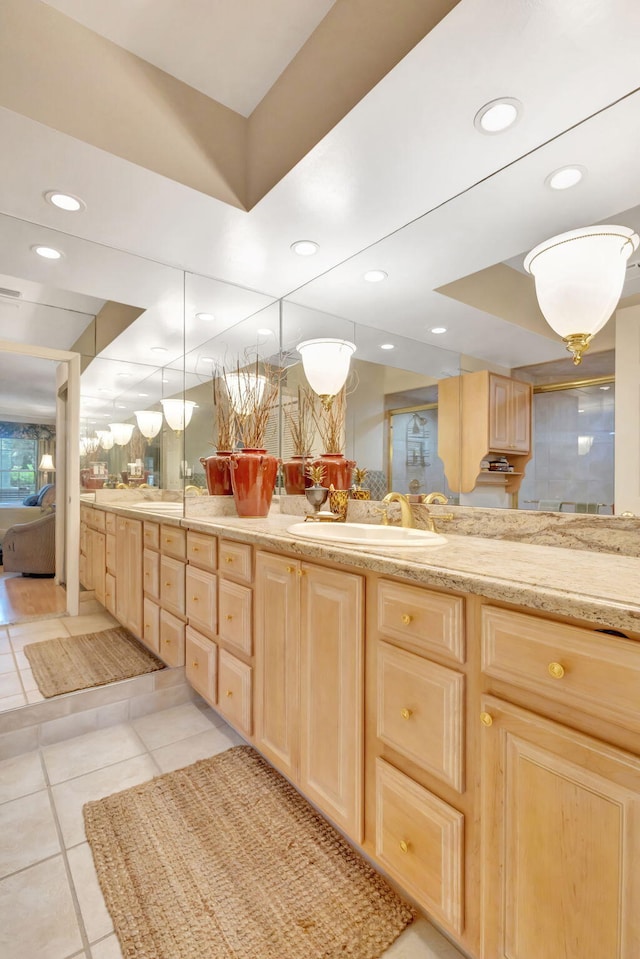 full bathroom with double vanity, a raised ceiling, tile patterned floors, a sink, and recessed lighting