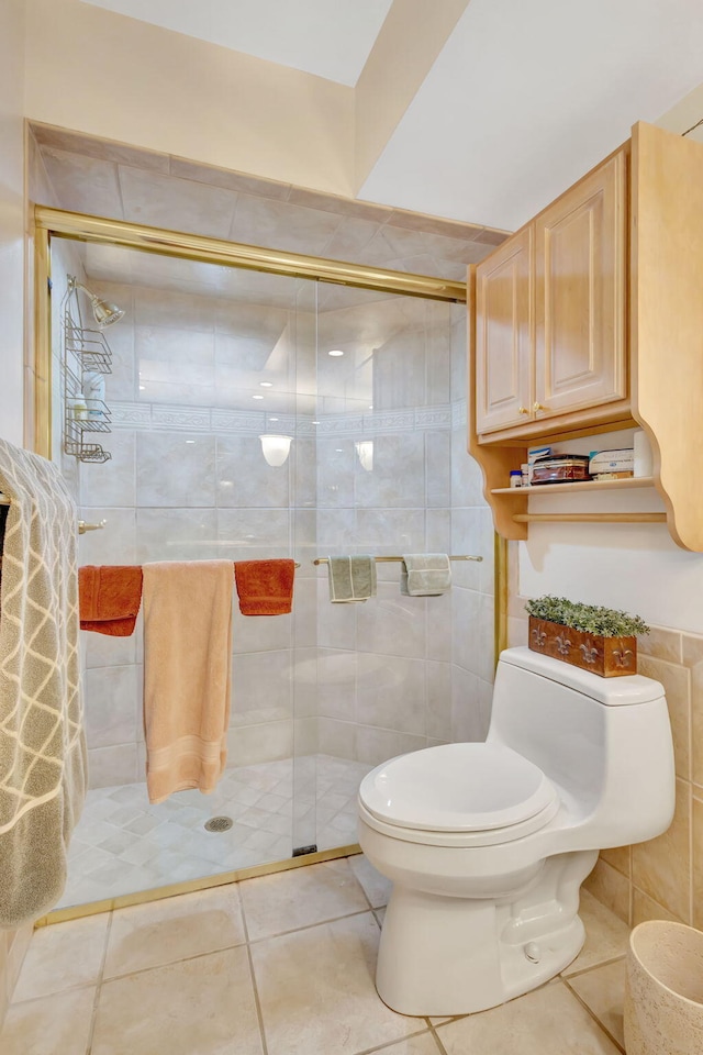 full bathroom featuring a shower stall, toilet, and tile patterned floors