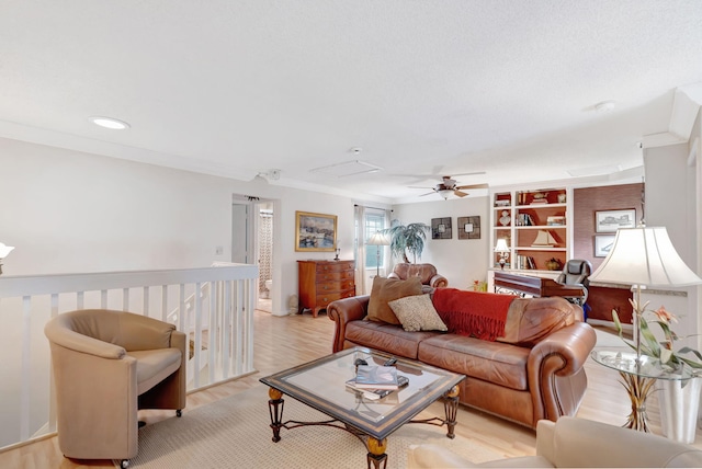 living area with light wood finished floors, a ceiling fan, crown molding, and recessed lighting