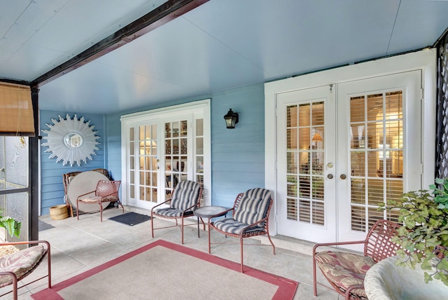 sunroom / solarium featuring french doors and beamed ceiling