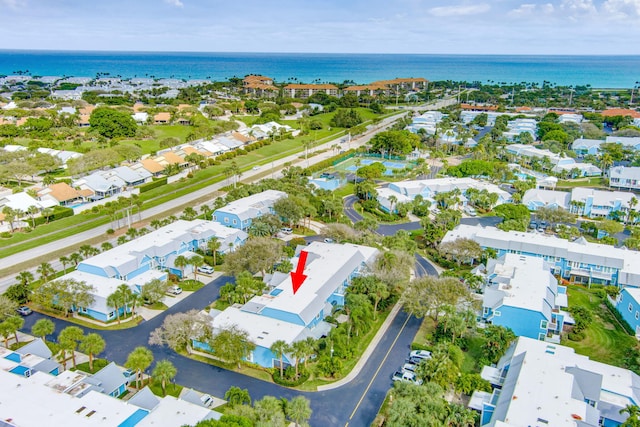 birds eye view of property featuring a water view and a residential view