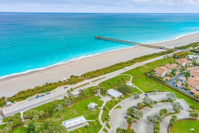 drone / aerial view with a beach view and a water view