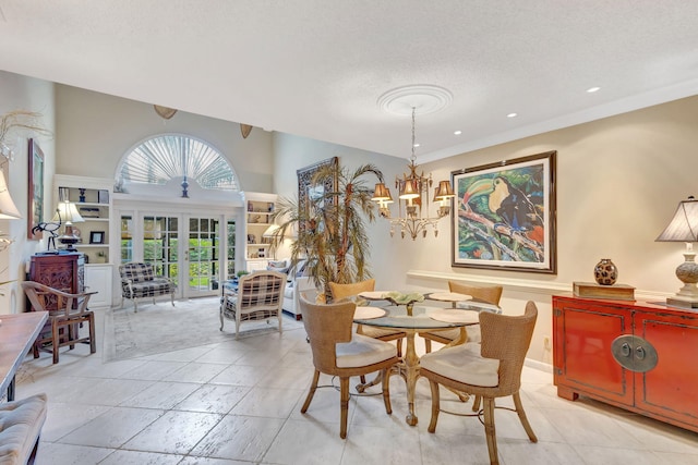 dining room with a textured ceiling, french doors, a notable chandelier, and recessed lighting