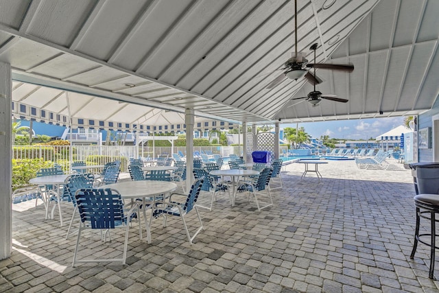 view of patio / terrace with outdoor dining space, fence, and a ceiling fan