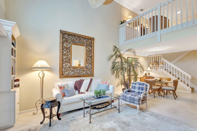 living room featuring a high ceiling, baseboards, and light tile patterned floors