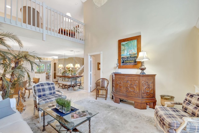 tiled living room with a towering ceiling and stairs