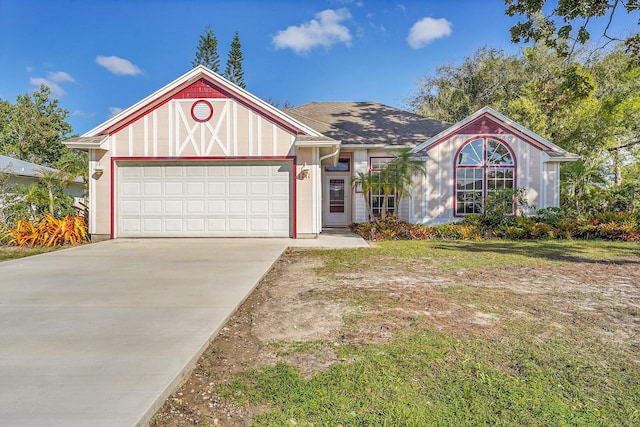 view of front facade featuring a garage, concrete driveway, and a front yard