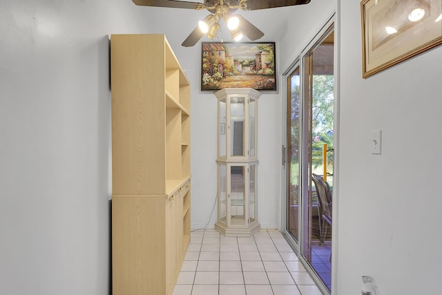 interior space featuring light tile patterned floors and ceiling fan