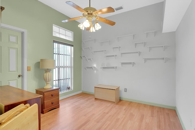 office space with light wood-type flooring, baseboards, visible vents, and a ceiling fan