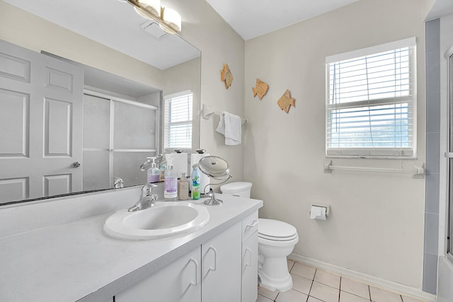 bathroom with baseboards, bath / shower combo with glass door, toilet, tile patterned flooring, and vanity