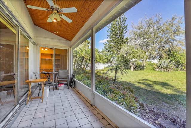 unfurnished sunroom with lofted ceiling, a water view, wood ceiling, and a ceiling fan