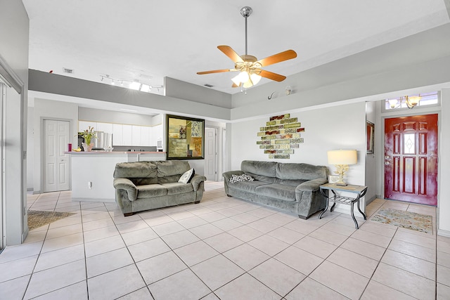 living room with light tile patterned flooring, visible vents, and a ceiling fan