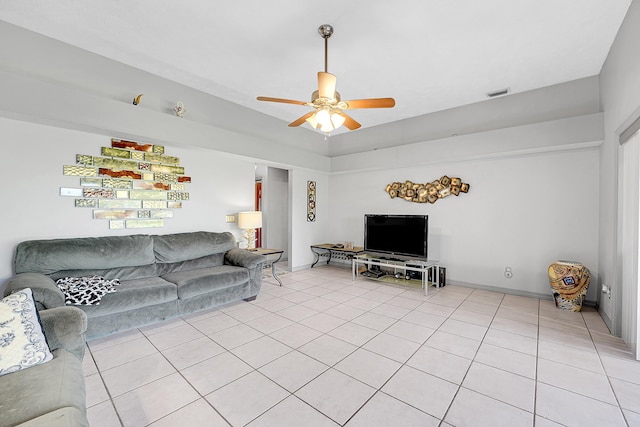 living room with light tile patterned floors, baseboards, visible vents, and a ceiling fan