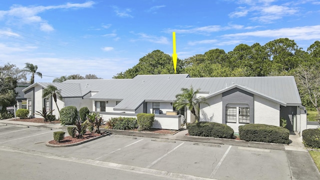 view of property featuring uncovered parking