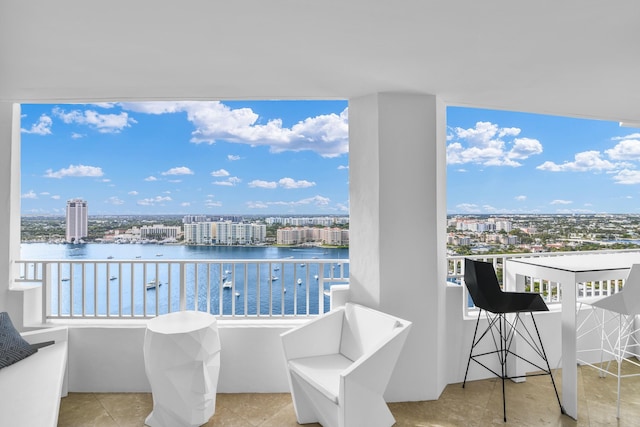 balcony featuring a view of city and a water view