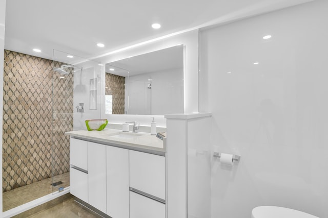 full bathroom with recessed lighting, vanity, toilet, and a walk in shower