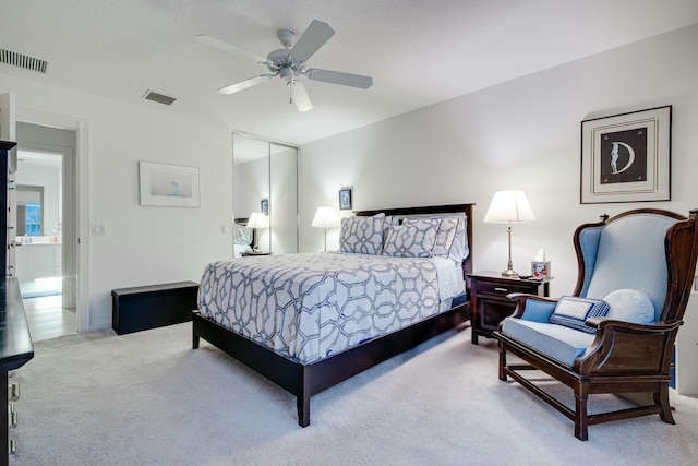 bedroom with carpet, visible vents, and ceiling fan