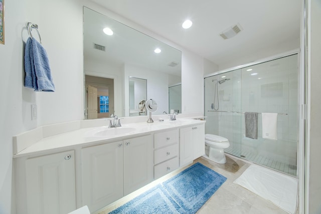 bathroom with double vanity, a sink, visible vents, and a shower stall