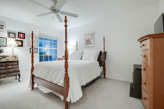 bedroom featuring light colored carpet, ceiling fan, and baseboards