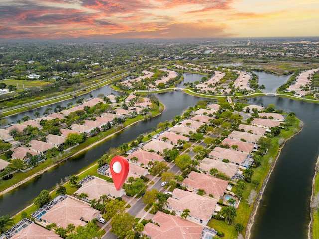 birds eye view of property with a water view and a residential view