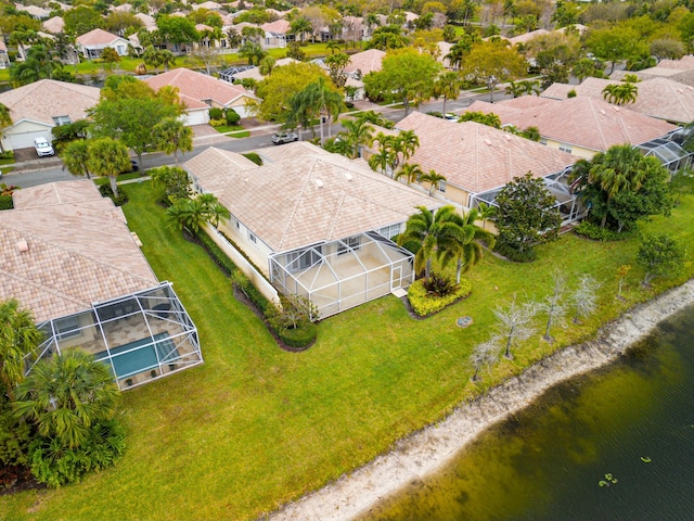 drone / aerial view with a water view and a residential view