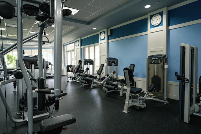 gym with a paneled ceiling and recessed lighting