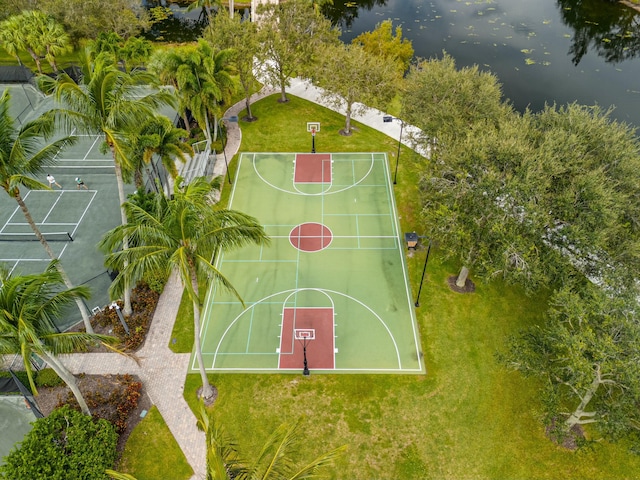 view of basketball court with a yard, a water view, and community basketball court