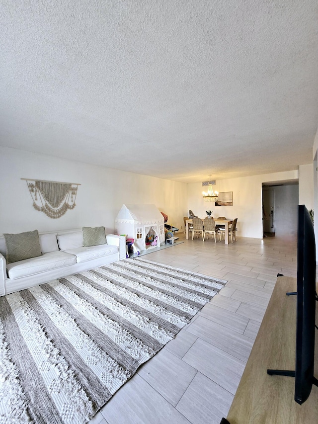 living area featuring a textured ceiling and light wood-style flooring