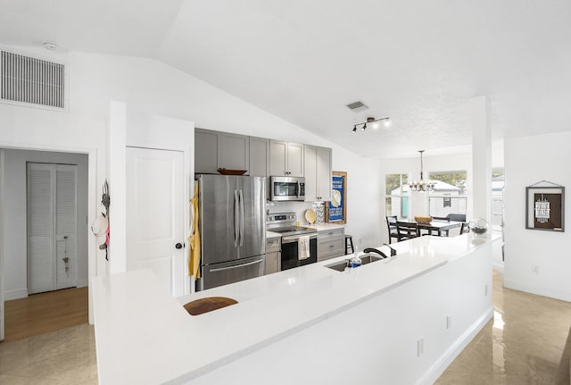 kitchen featuring stainless steel appliances, hanging light fixtures, light countertops, and visible vents