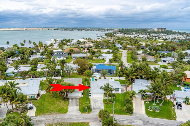 birds eye view of property with a water view and a residential view