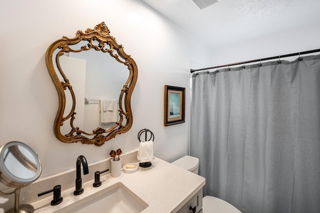 full bath featuring visible vents, vanity, and toilet