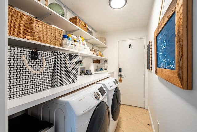 clothes washing area featuring laundry area, independent washer and dryer, and light tile patterned floors