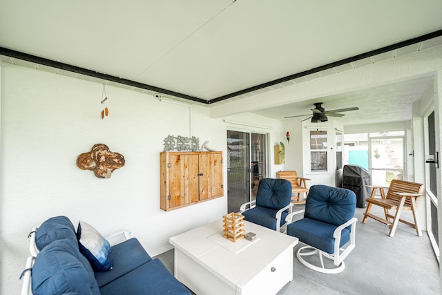 living area with concrete floors and ceiling fan