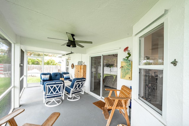 sunroom / solarium featuring a ceiling fan