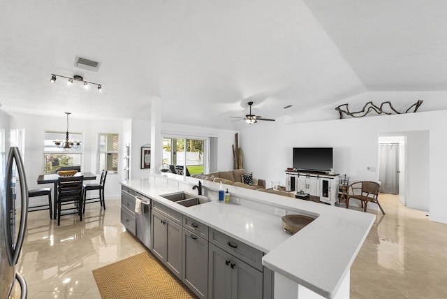 kitchen with refrigerator, a sink, marble finish floor, light countertops, and gray cabinets