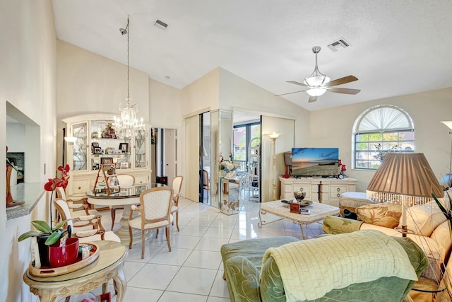 living room with lofted ceiling, light tile patterned floors, visible vents, and ceiling fan with notable chandelier