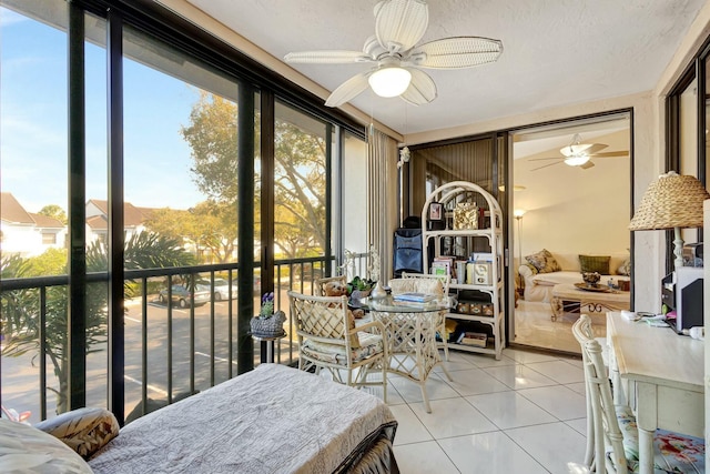 sunroom featuring a ceiling fan