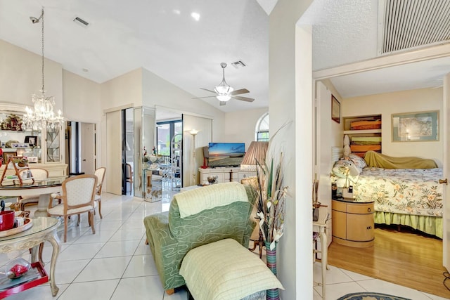 bedroom featuring light tile patterned floors, lofted ceiling, and visible vents