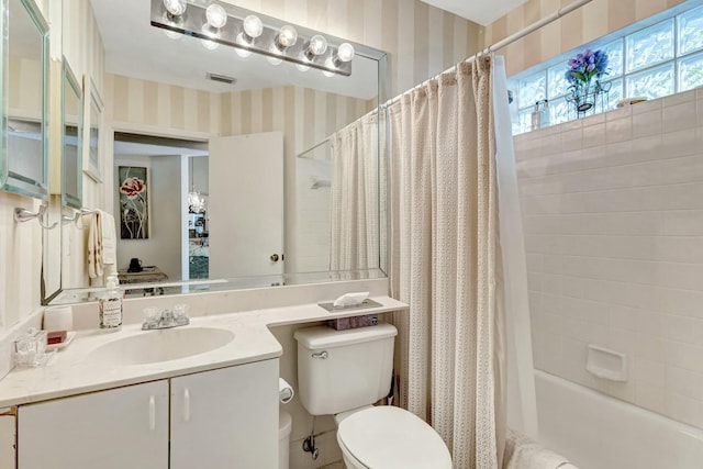 bathroom with wallpapered walls, visible vents, toilet, shower / bathtub combination with curtain, and vanity