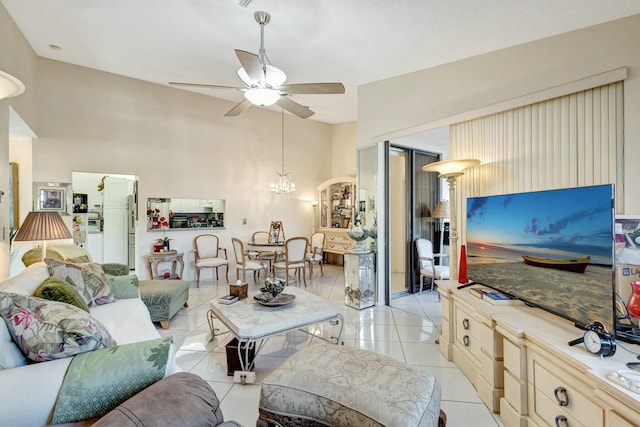 living room with ceiling fan with notable chandelier and light tile patterned floors