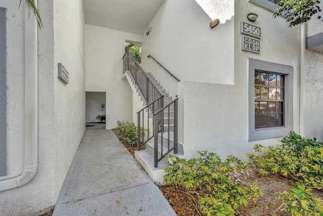 property entrance with stucco siding