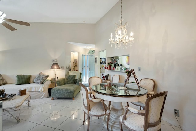 dining area featuring a ceiling fan, a towering ceiling, and light tile patterned floors