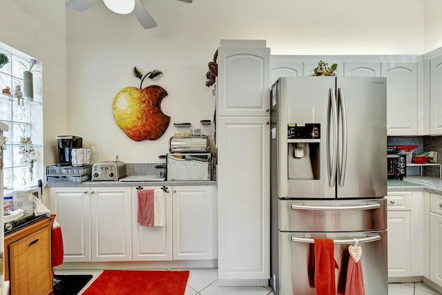 kitchen featuring a ceiling fan, white cabinetry, stainless steel fridge with ice dispenser, and light tile patterned floors