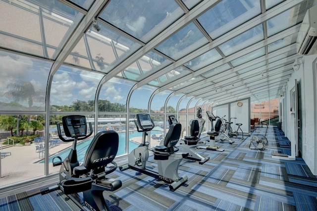 gym featuring a wall mounted air conditioner and carpet flooring